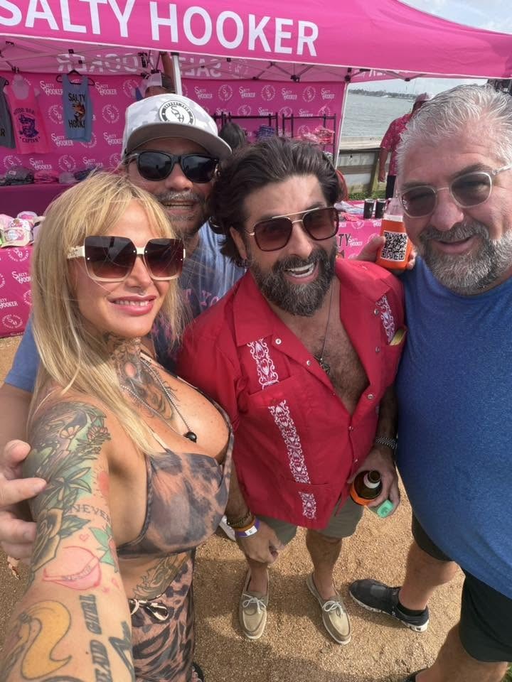 Friends together at a NautiFest vendor tent