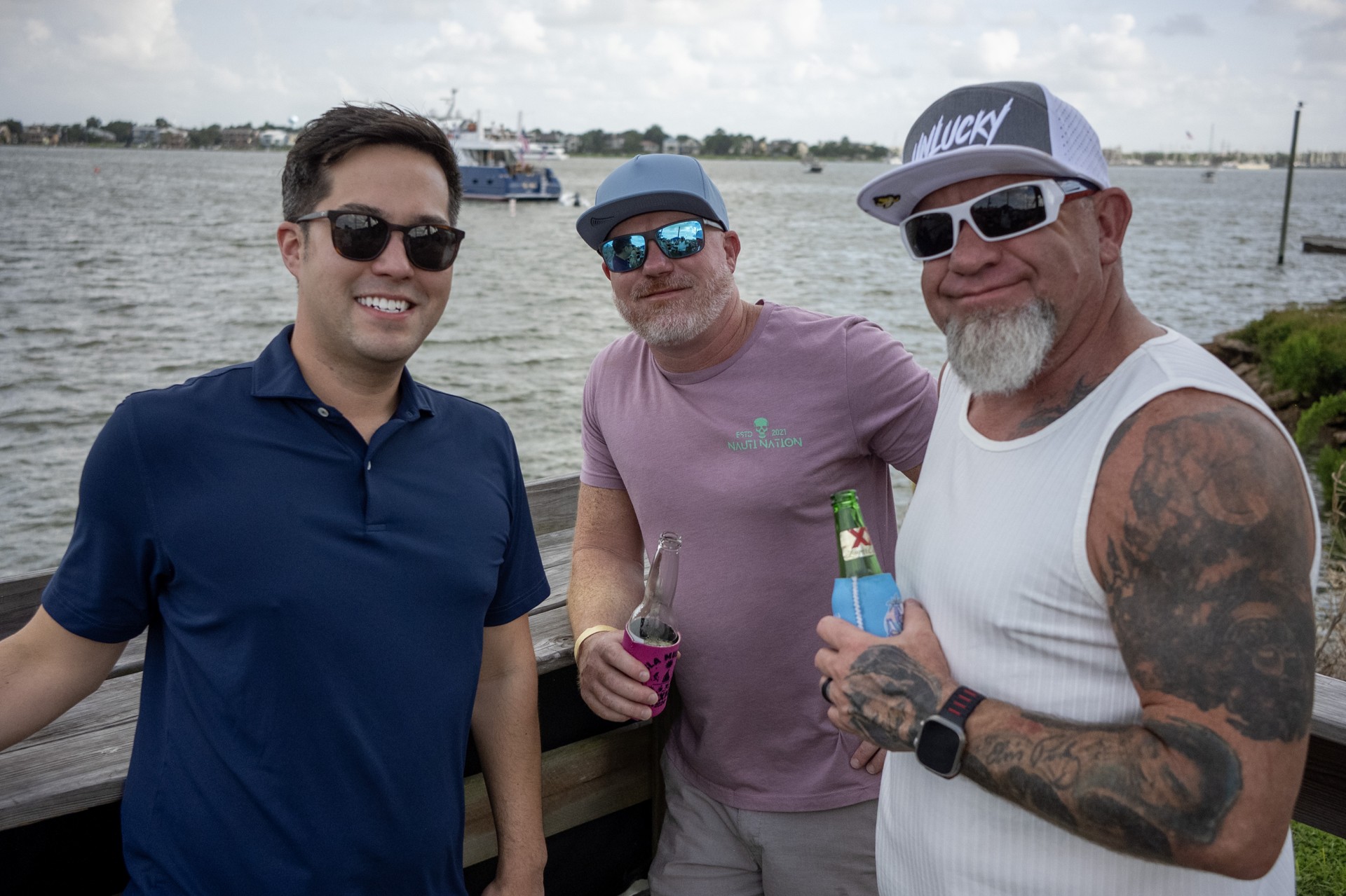 Three attendees by the water at NautiFest 2026