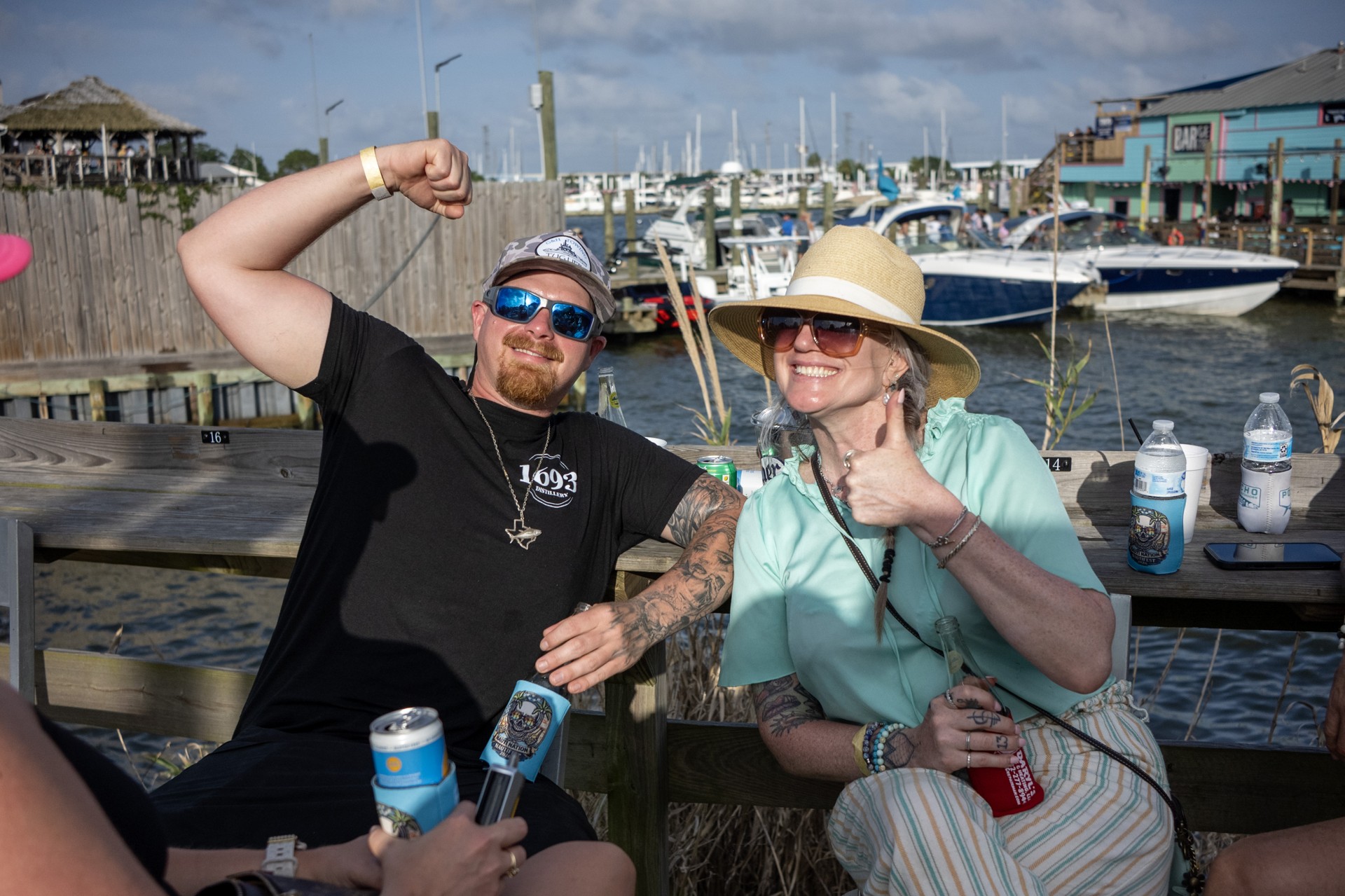 Friends celebrating beside the boats and marina